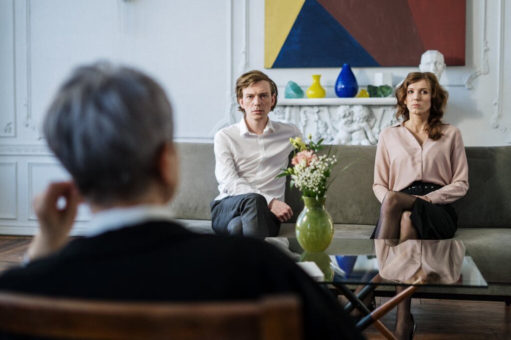 A couple consulting with a therapist in a modern studio setting.